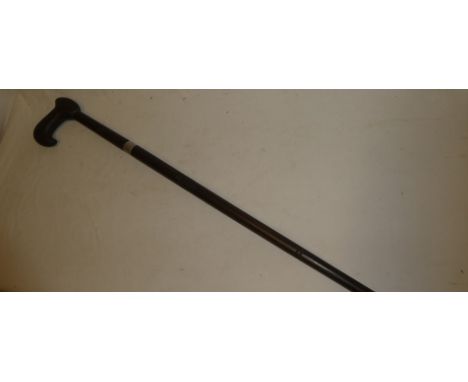 An Indian sword stick with 10" double edged steel blade in carved teak mounts
