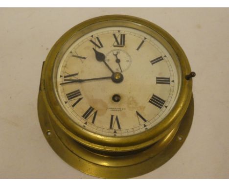 A ship's clock with painted circular dial by Camerer Cuss &amp; Co London in brass cylindrical case