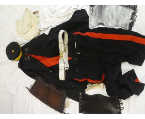 An Officer's blue cloak bearing Victorian crowned brass Royal Artillery buttons; a Royal Artillery pill-box hat, leather wais