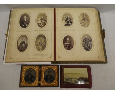 A Victorian brass mounted family photograph album containing a selection of various carte de visites and other photographs to