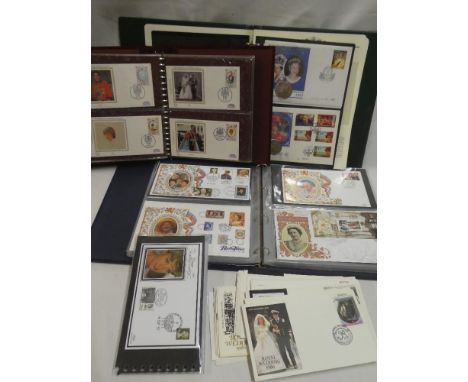 Three albums containing a selection of commemorative first day covers, coin covers, Benham silk covers and others together wi