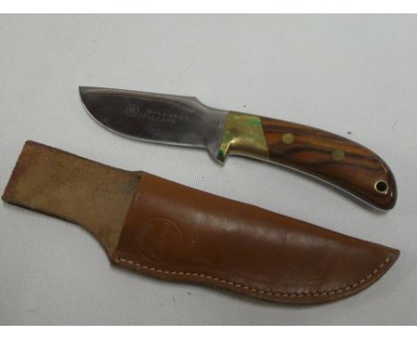 A modern hunting knife by Holland and Holland with polished wood grips in leather sheath