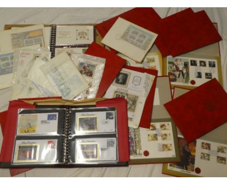 A selection of commemorative first day covers in folder wallets, two albums of Benham silk postal covers, etc