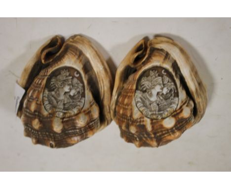 A PAIR OF CARVED CONCHE SHELLS