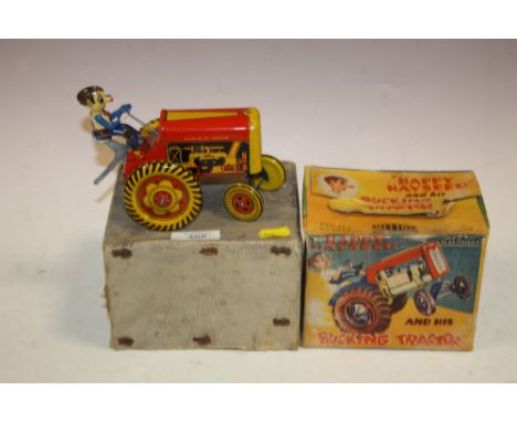 A BOXED METTOY PLAYTHINGS HAPPY HAYSEED AND BUCKING TRACTOR VINTAGE TIN PLATE TOY