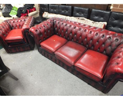 AN OXBLOOD RED CHESTERFIELD THREE SEATER SOFA TOGETHER WITH MATCHING ARMCHAIR (2)