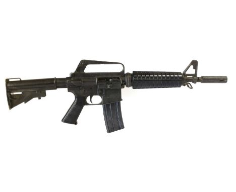 A Japanese Non-working Copy of an M16 Assault Rifle, in blackened cast metal, with detachable magazine.