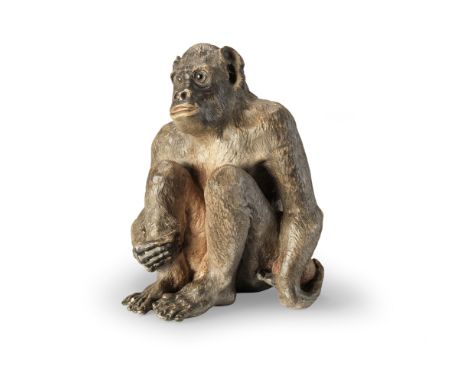 A painted terracotta model of a monkeyEarly 20th centuryNaturalistically modelled in a seated position, with glass eyes, hold