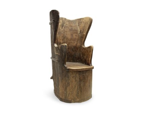 An elm wing back dug out chairLate 19th / early 20th century in the 17th century style The shaped wing back above with solid 