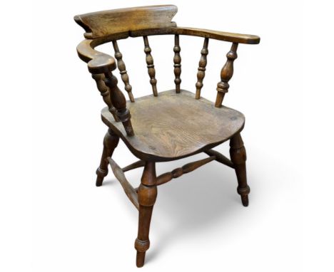 An early 20th century beech and elm bow back smoker's chair c.1920