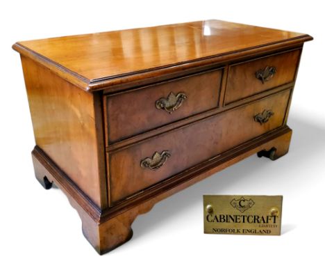A George III style burr walnut television cabinet made by Cabinetcraft Ltd, Norfolk, fall front, bracket feet, castors 42cm x