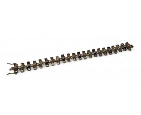 A unusual Cypriot silver bracelet each link set with alternating purple amethyst, Peridot and Citrine baguettes stones, the l