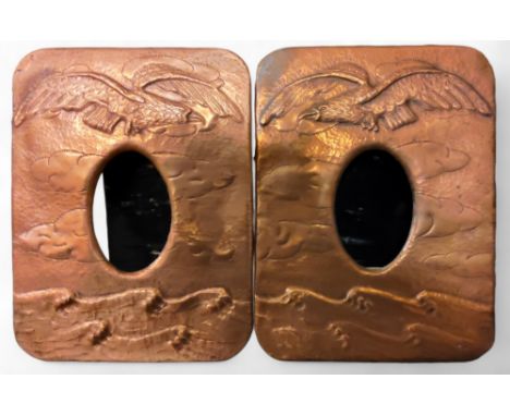 A pair of 20th century copper rounded rectangular easel photographs, embossed with bird pf prey and waves, 25cm high, 19cm wi