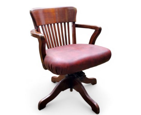 An early 20th century mahogany iron bound captain's chair, later burgundy leatherette upholstered seat c.1940