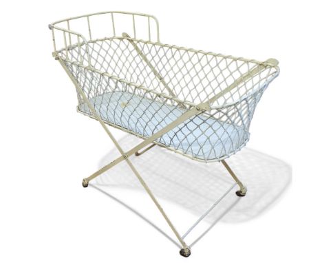 An early 20th century cream painted wrought iron cot, x-frame, 92 h x 106 cm