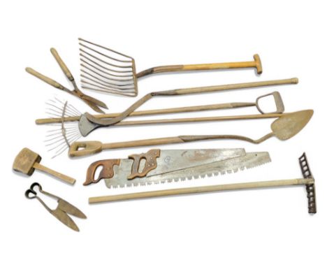 Agricultural bygones - an early 20th century hay pitch fork; sheering scissors; saws; edging tools; peat shovel; etc