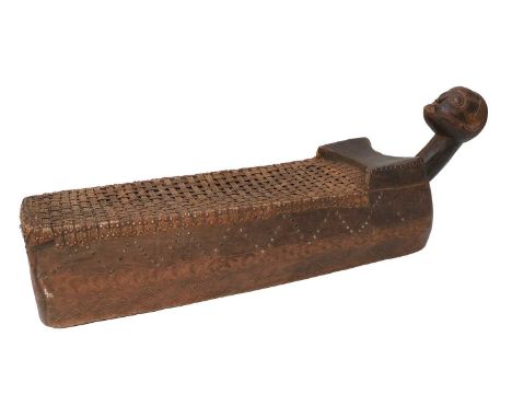 A Rare Mid-20th Century Tabwa Birthing Bed, Congo, the rectangular box base carved from a hollowed out tree trunk, with chevr