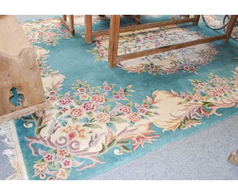 A 'Savonnerie' Design Carpet, the jade floral field centred by a medallion, 370cm by 272cm