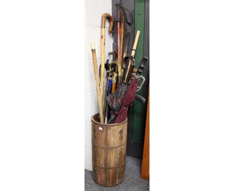 A Cylindrical Wooden Stick Stand with Metal Mounts, together with a quantity of walking sticks, walking canes, shepherds croo