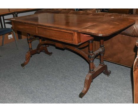 A George IV Mahogany Sofa Table, with two D-shaped flaps to the rectangular top and with two frieze drawers, on twin turned e