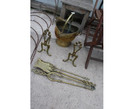 AN ASSORTMENT OF BRASS FIRE SIDE ITEMS TO INCLUDE A COAL BUCKET, FIRE DOGS AND TOOLS ETC 