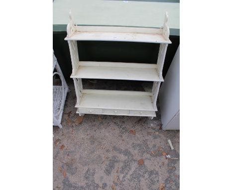 A WHITE PAINTED THREE TIER WALL SHELF ENCLOSING THREE DRAWERS, 26" WIDE 