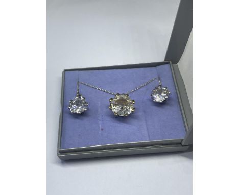 A SILVER CLEAR STONE NECKLACE AND EARRINGS IN A PRESENTATION BOX 