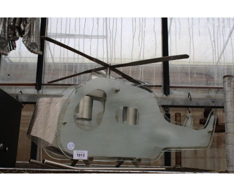 A GLASS CEILING LIGHT IN THE FORM OF A HELICOPTER 