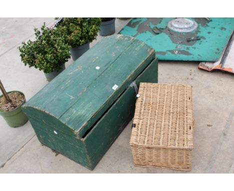 A VINTAGE WOODEN STORAGE TRUNK AND A WICKER HAMPER BASKET 