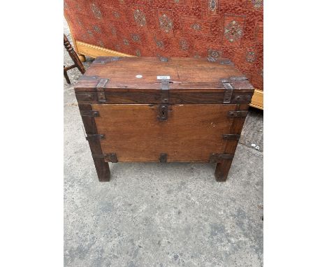 A SMALL HARD WOOD METAL BOUND TRUNK ON LEGS 