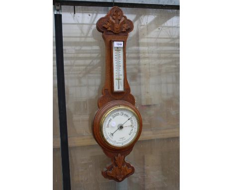 AN OAK CASED WALL HANGING BAROMETER 
