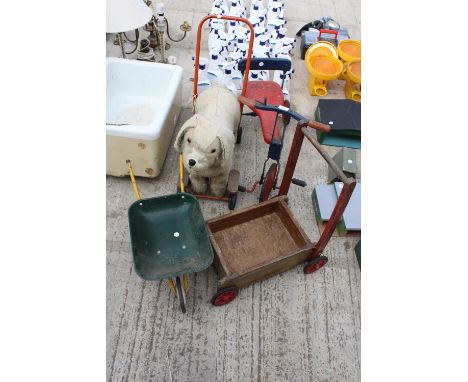 AN ASSORTMENT OF VINTAGE CHILDRENS TOYS TO INCLUDE A PUSH ALONG DOG AND A WHEEL BARROW ETC 