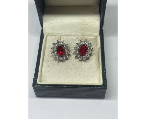 A PAIR OF SILVER AND RED STONE EARRINGS IN A PRESENTATION BOX 