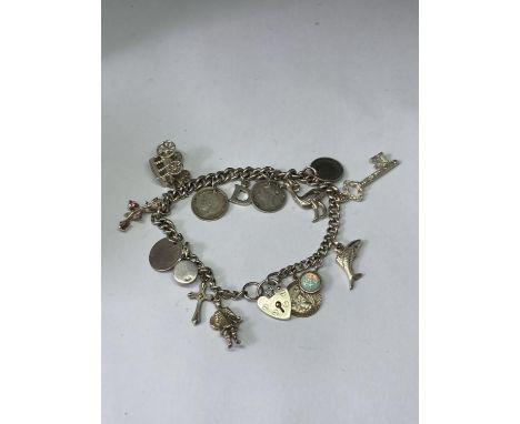A SILVER CHARM BRACELET WITH FIFTEEN CHARMS 