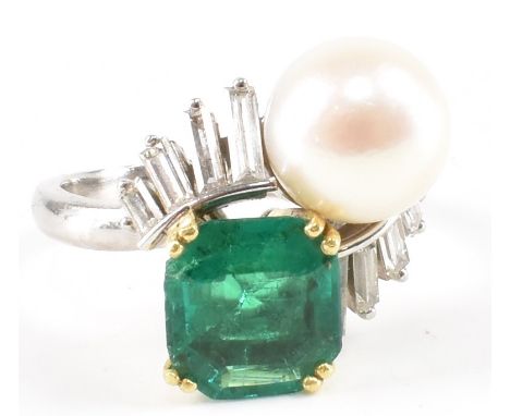 A French platinum and gold, emerald and pearl dress ring. The ring being set with an emerald cut emerald and a cultured pearl