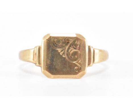 A vintage hallmarked 9ct gold signet ring. The ring having a square head with engraved scroll decoration to one corner.  Hall