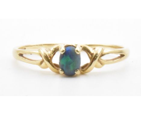 A vintage gold opal ring. The ring being set with an oval opal cabochon on twist gold shoulders. Marked 14K and 585. Weight 1