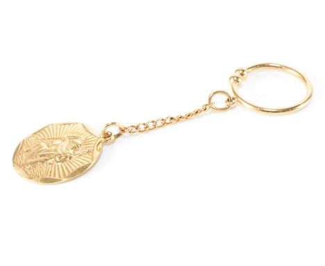 A vintage hallmarked 9ct gold key ring pendant. The circular pendant depicting the image of St Christopher suspended from a g