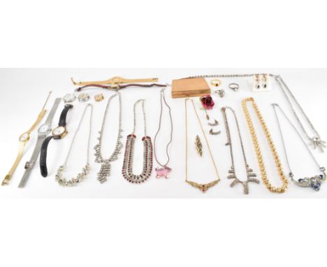 An assortment of silver, costume jewellery and watches. The lot to include a silver shell cameo necklace, a Swaroski cat neck