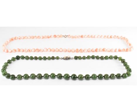 A sterling silver nephrite necklace together with an angel skin coral necklace with 9ct clasp. The graduated nephrite necklac