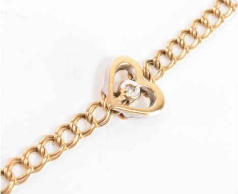 A vintage 9ct gold diamond heart necklace. The gold chain link necklace set with a small diamond to the gold heart. Hallmarke