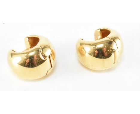A pair of vintage hallmarked 18ct gold hoop earrings. The earrings of plain tapering form with a hinged opening and post fast