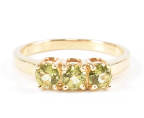 A hallmarked 9ct gold and green stone ring. The ring being prong set with three round cut green stones to the head on a plain