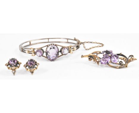 A 19th Century Victorian amethyst and seed pearl jewellery suite. The lot to include a bracelet, brooch and earrings. The set