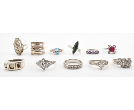 A group of eleven silver stone set dress rings. The lot to include a marcasite set panel ring, a malachite set ring, an engra