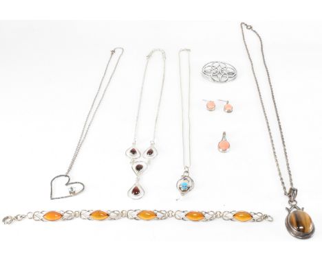 An assortment of silver jewellery to include a silver and red stone collar necklace (marked 925), a silver and tigers eye pen