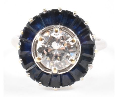 An 18ct gold diamond and sapphire Art Deco target ring. The ring bring prong set with a central round brilliant cut diamond w