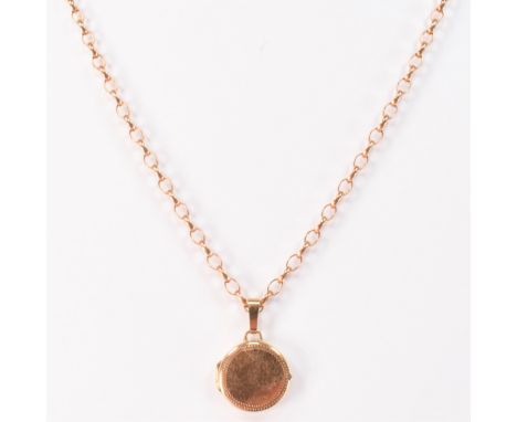 A vintage hallmarked 9ct gold locket pendant necklace. The pendant of round form mounted to an oval link necklace chain with 