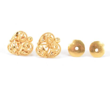 A pair of Indian high carat gold stud earrings on screw post fittings. The earrings having bead and twist decoration. Unmarke