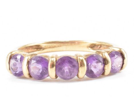 A hallmarked 9ct gold and amethyst ring. The ring being set with five round cut amethysts. Hallmarked Birmingham 2002. Weight